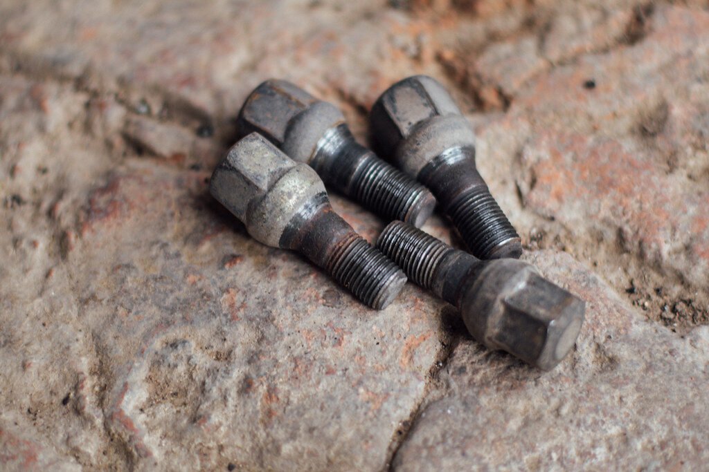 Close-up of lug nuts on the ground