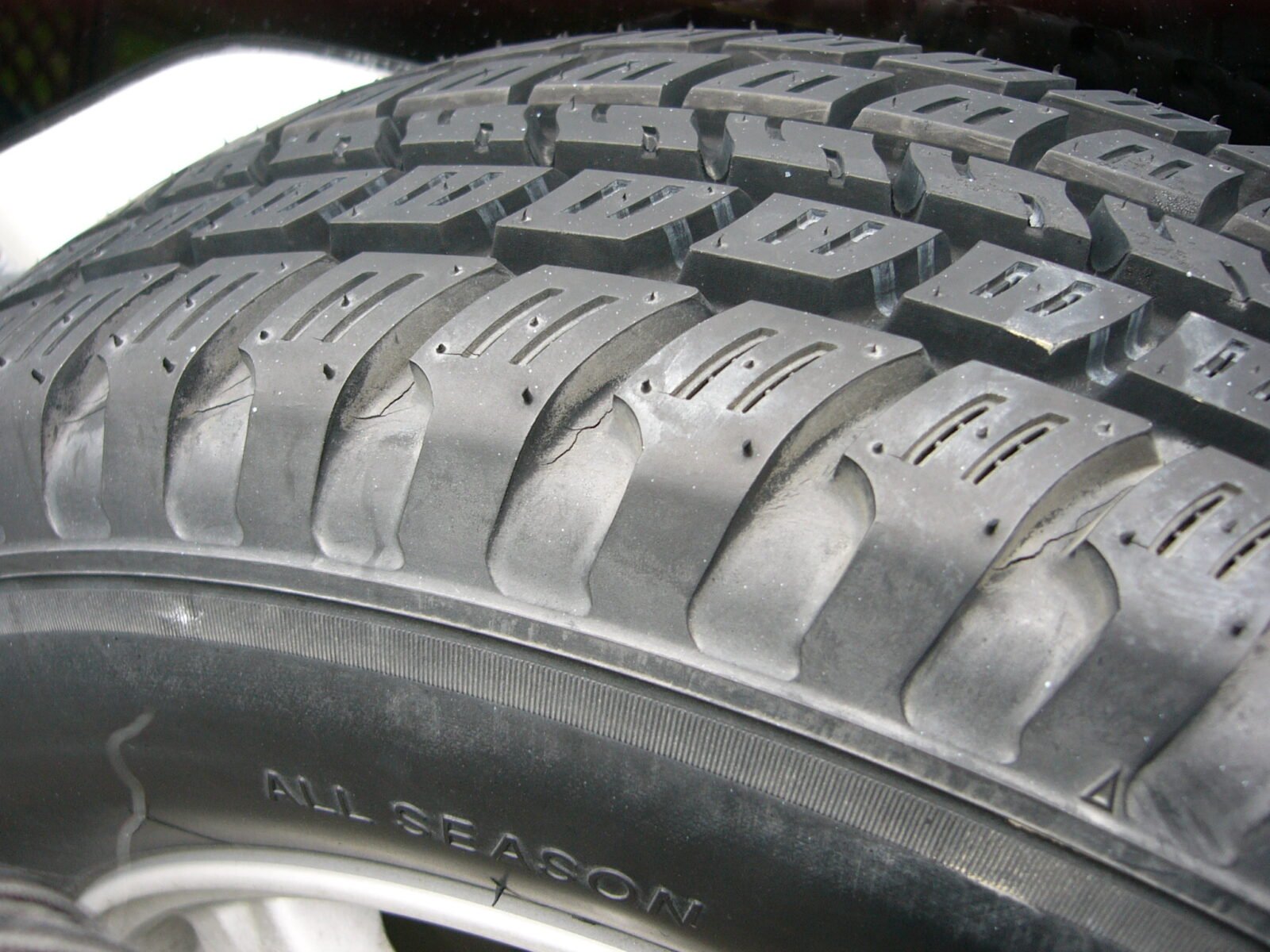 All-season tire tread and sidewall code